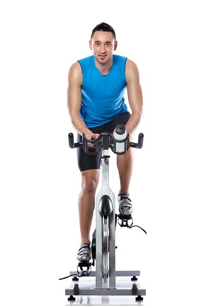 19405039 - young man exercising on a bike, spinning exercise class
