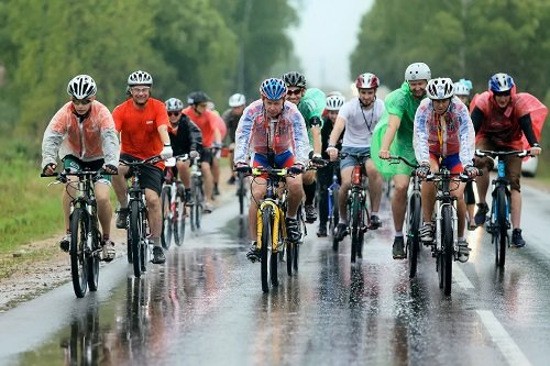 A group of cyclist racer racing in the rain