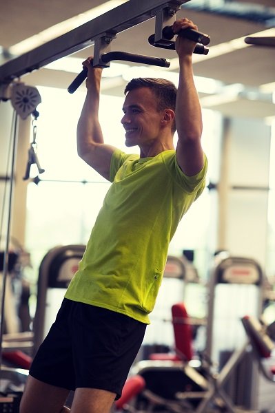 smiling man exercising in gym