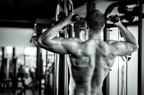 Man doing pull ups in gym