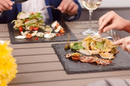 Close-up of people eating in restaurant.